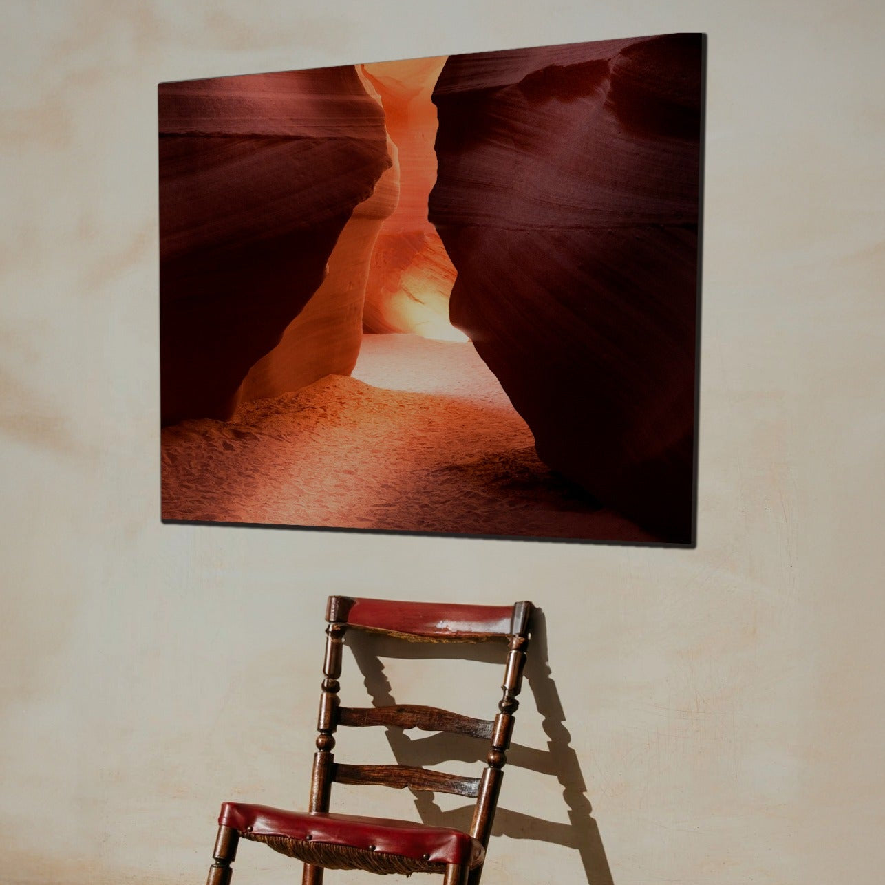 Landscape metal art print on wall above single chair