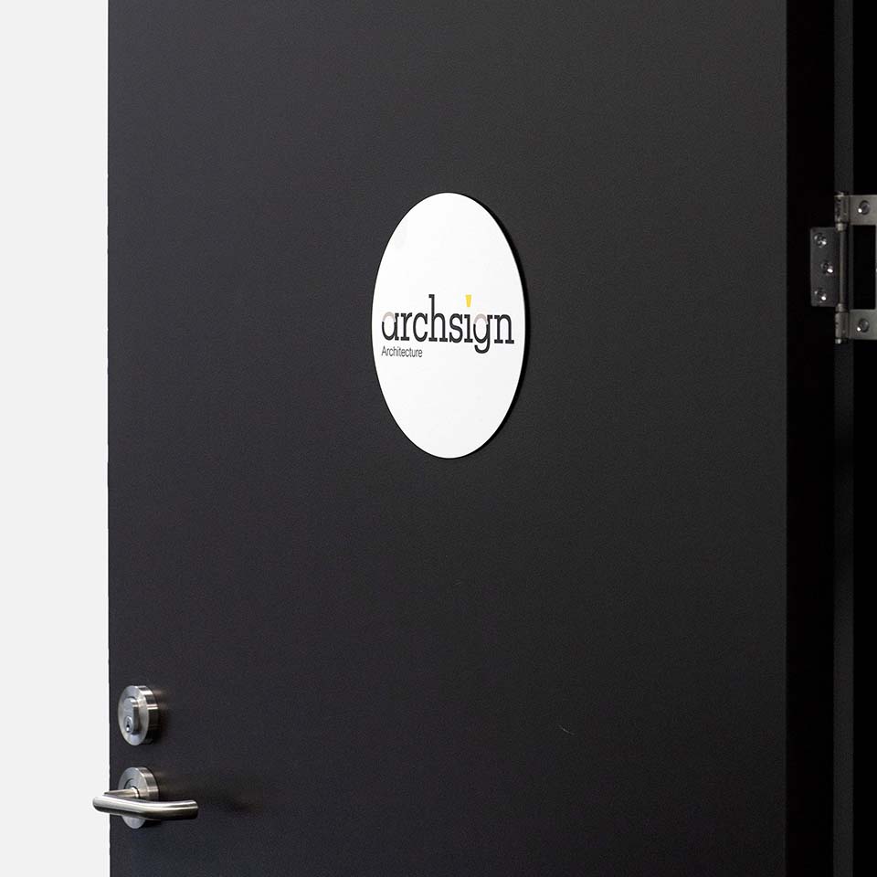 Branded metal circle sign on door