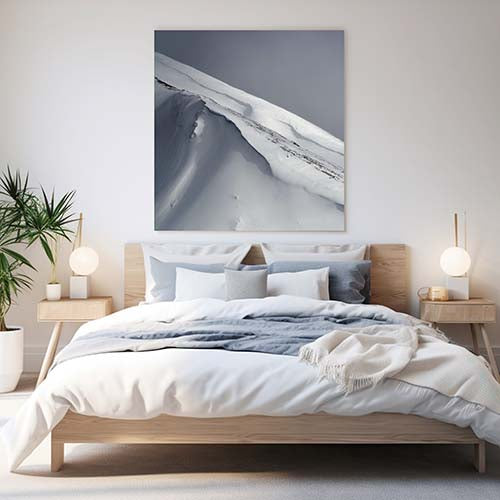 Metal print on bedroom wall above bed