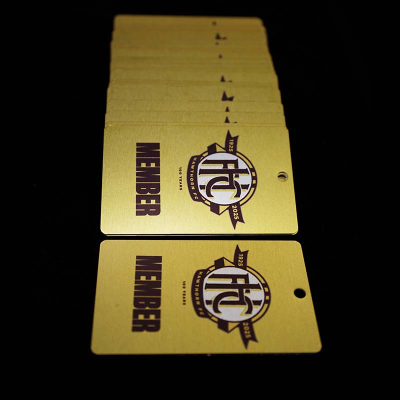 Hawthorn Football Club 100 years - metal membership cards spread out on table vertically