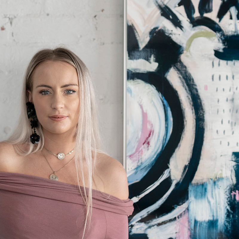 Jenna in front of her metal artwork