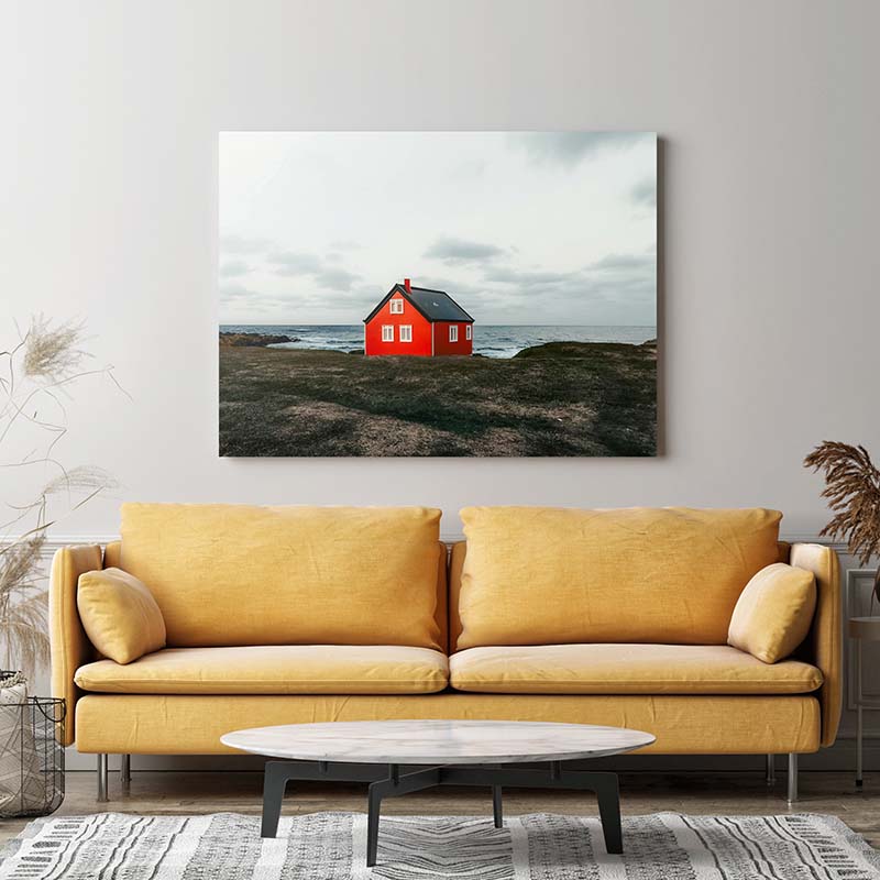 Metal print of red hut on edge of cliff