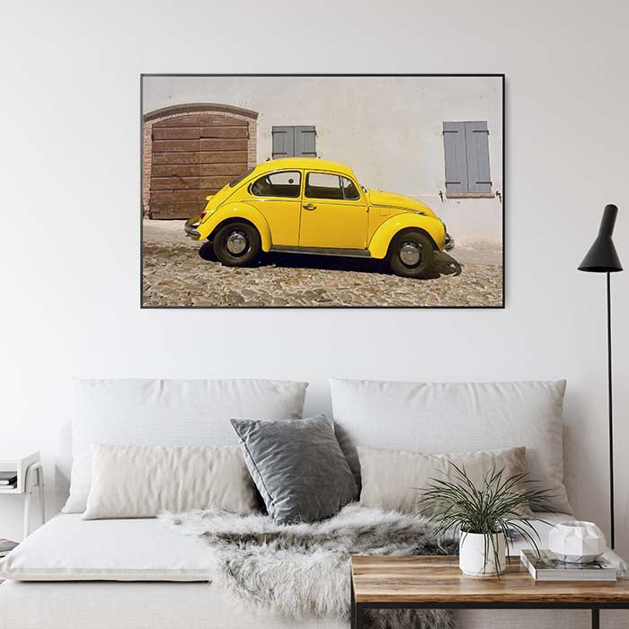 Photo of yellow car on metal on wall in lounge