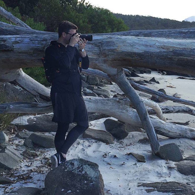 Rob Wengritzky taking a photo on the beach