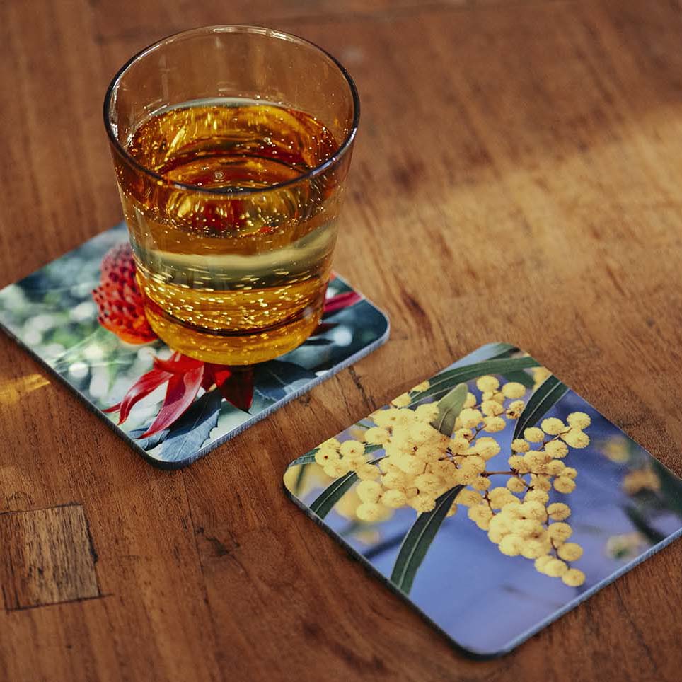 Custom print coasters with glass on table