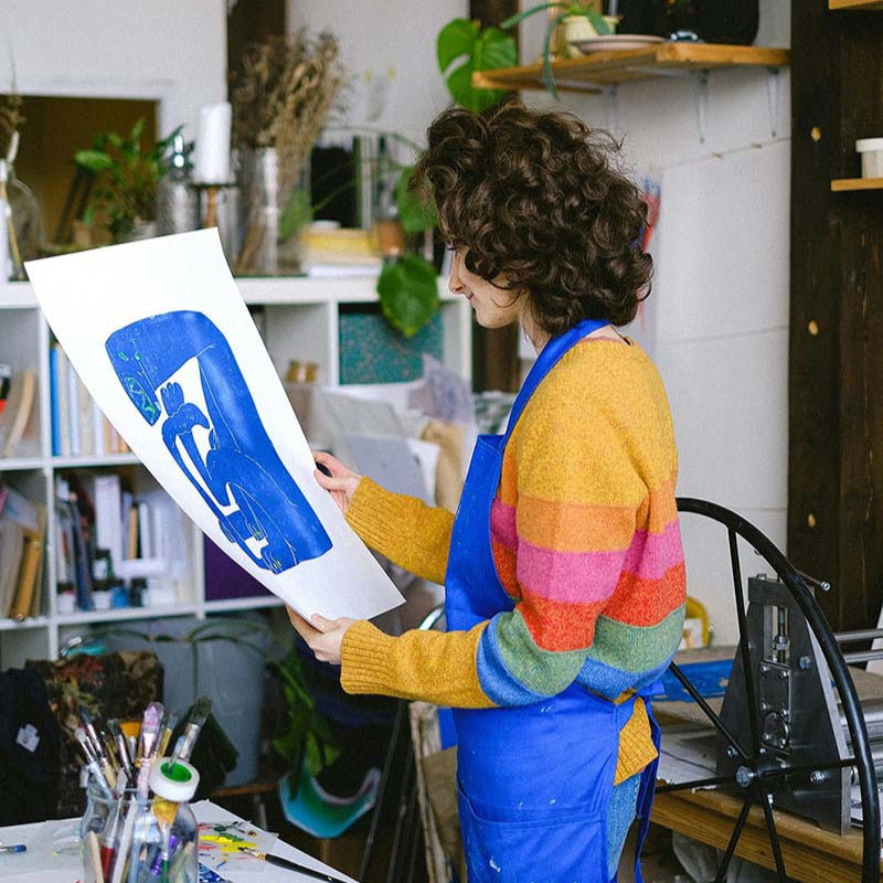 Artist looking at her art in studio